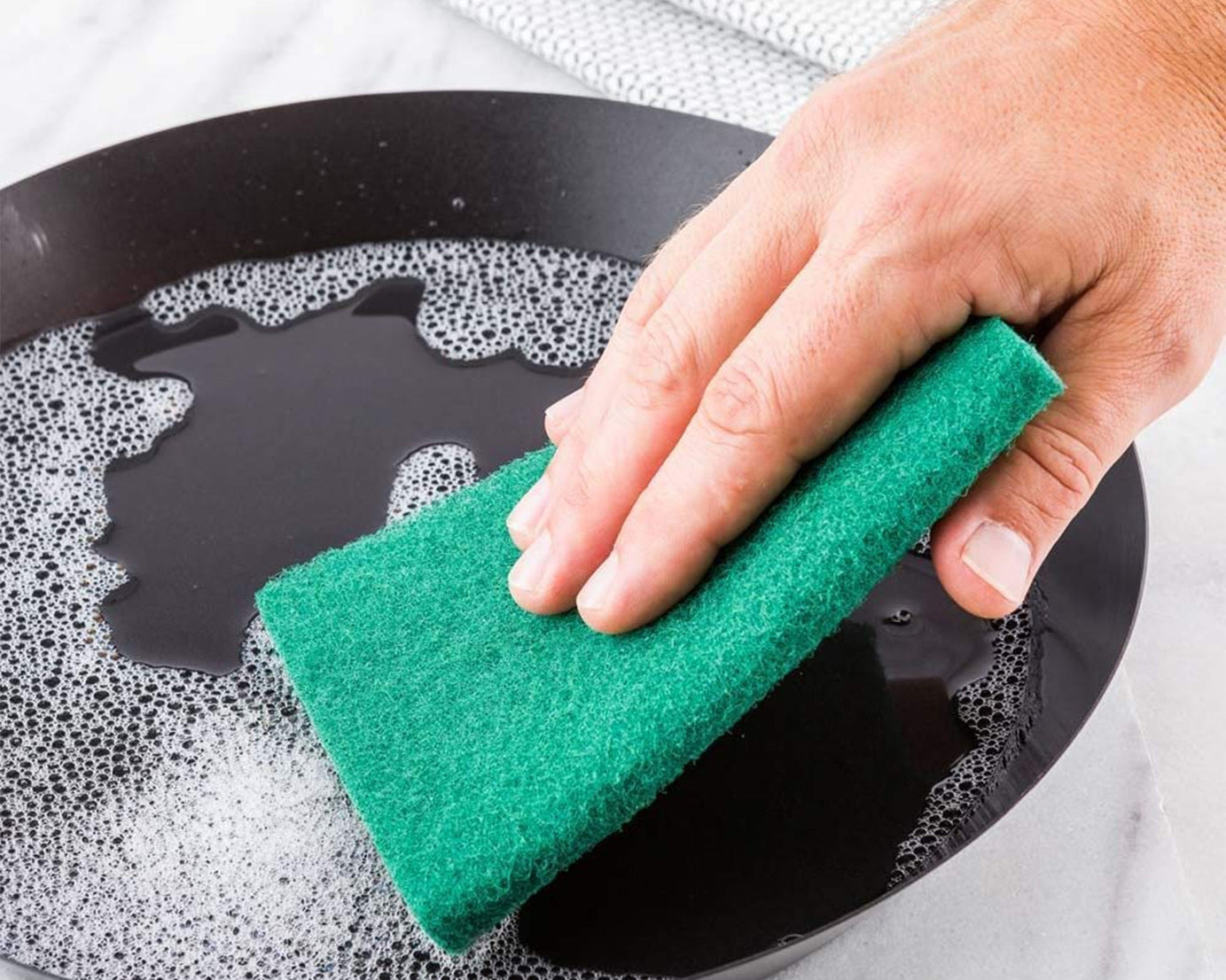 Set of 10 aqua green scrub sponges for cleaning.