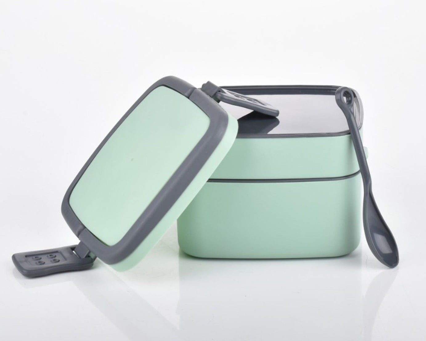 Stackable green lunch box with spoon for everyday use