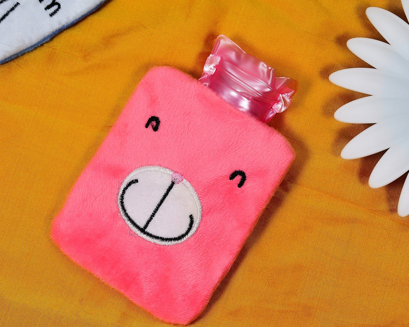 Small pink hot water bag for neck and shoulder pain relief