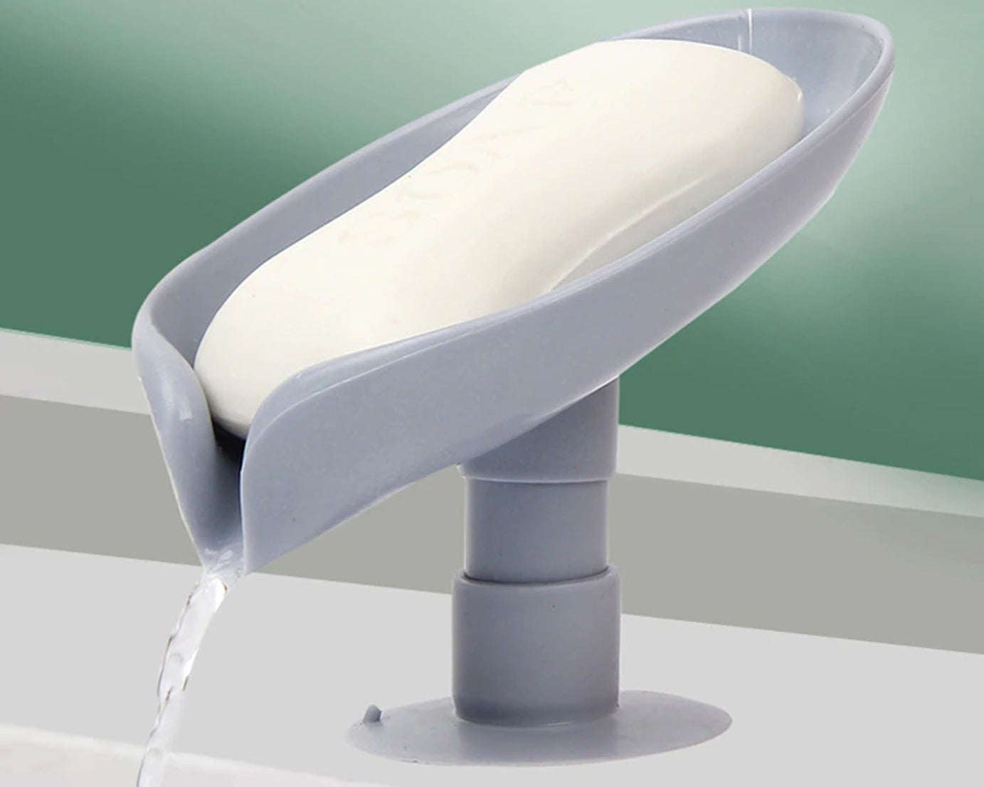 Self-draining soap holder in leaf shape for bathroom or kitchen.