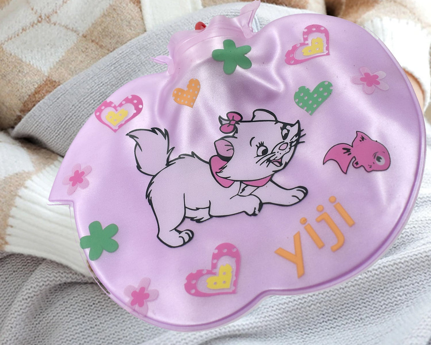 Hot water bottle for pain relief in apple shape.