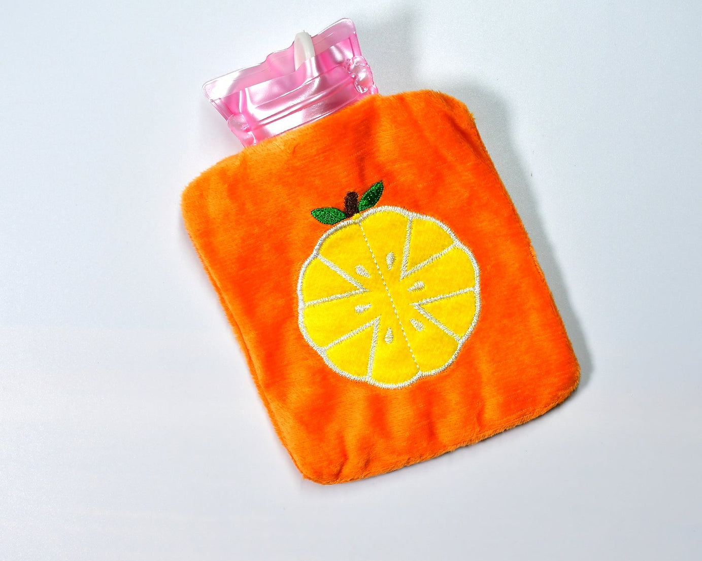 Orange hot water bag with cover for pain relief and warmth