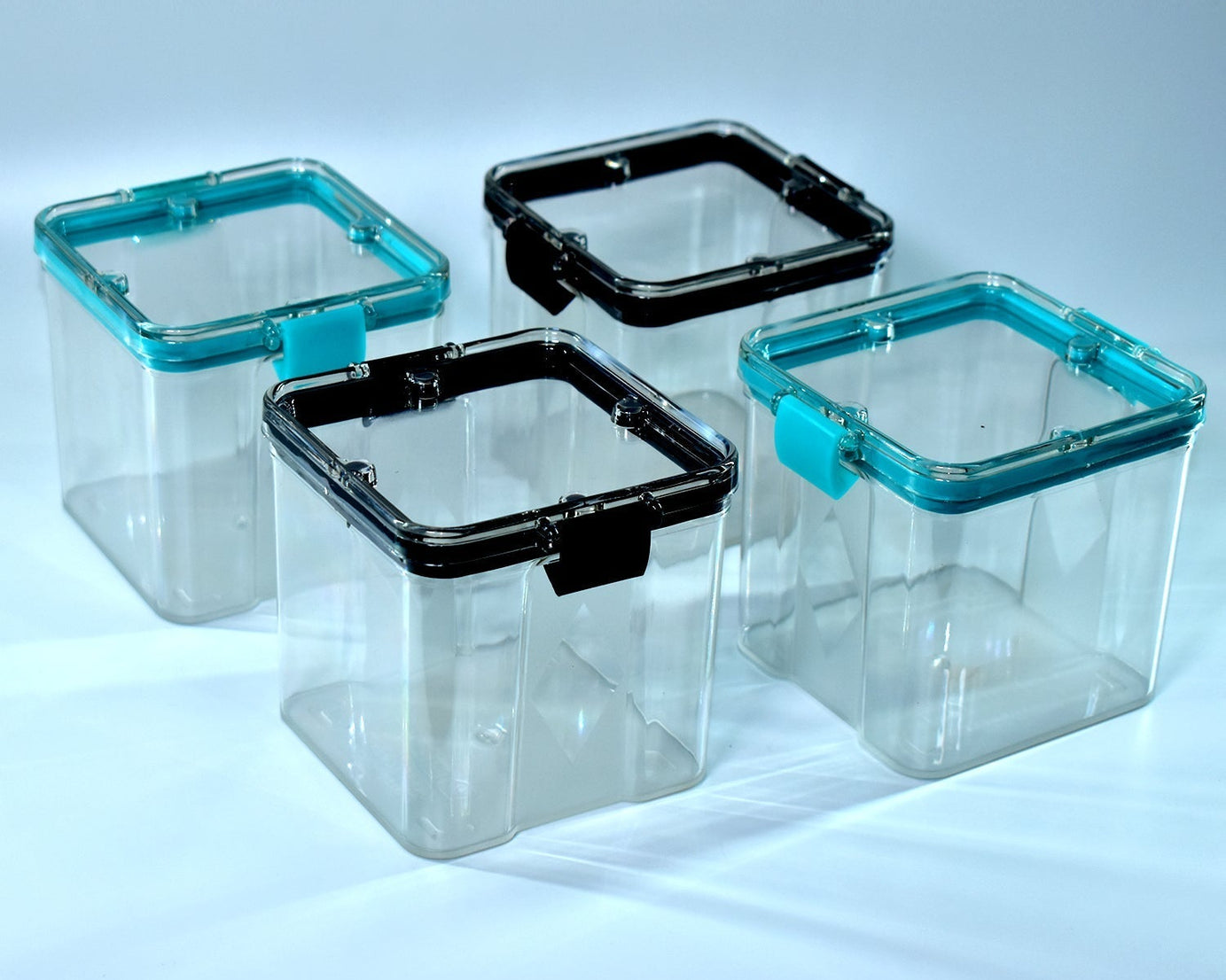 Set of four 700ml square containers, ideal for storing various food items.