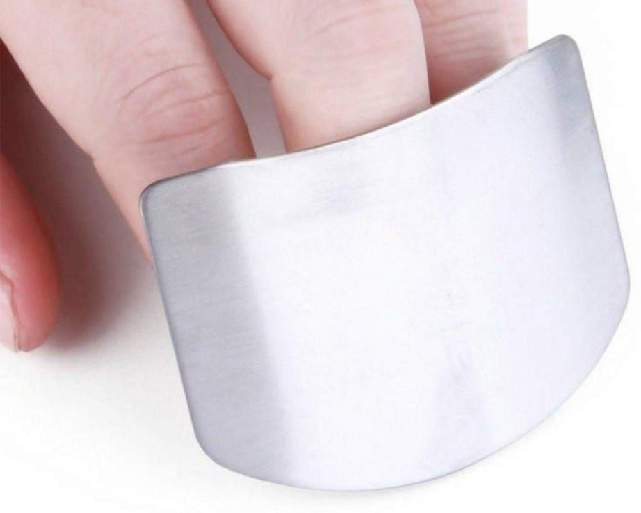 Stainless steel finger guard for safe cutting in kitchen.