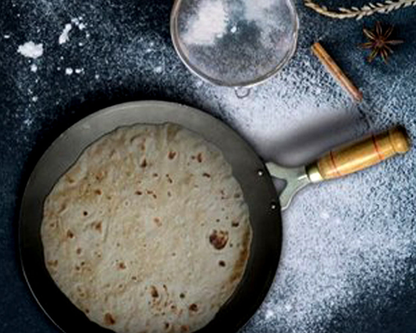 Wooden handle tawa with nonstick coating, perfect for home kitchens.