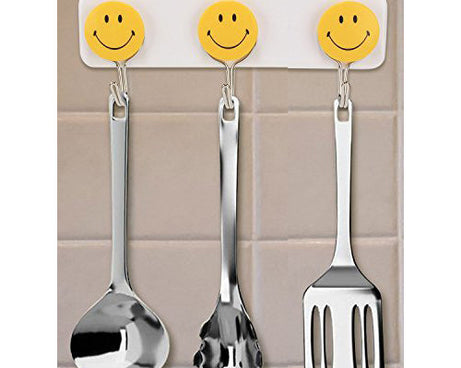 Pack of 3 self-adhesive smiley hooks for home use.