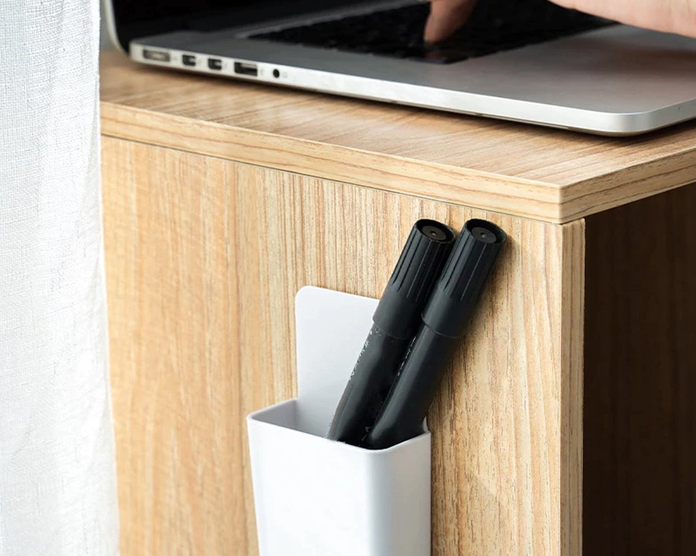 Wall-mounted holder for charging and storage.