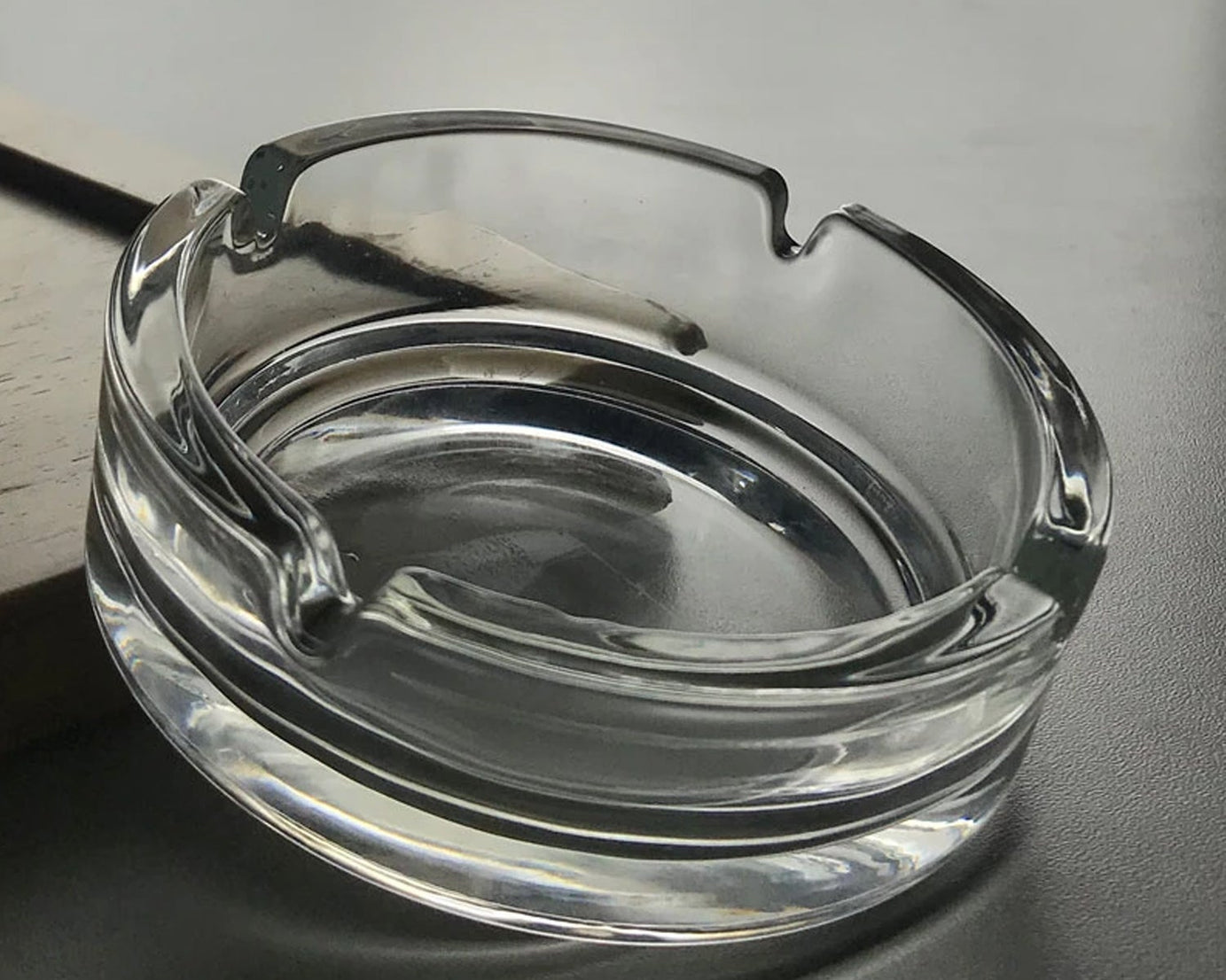 High-quality crystal ashtray for indoor and outdoor settings.