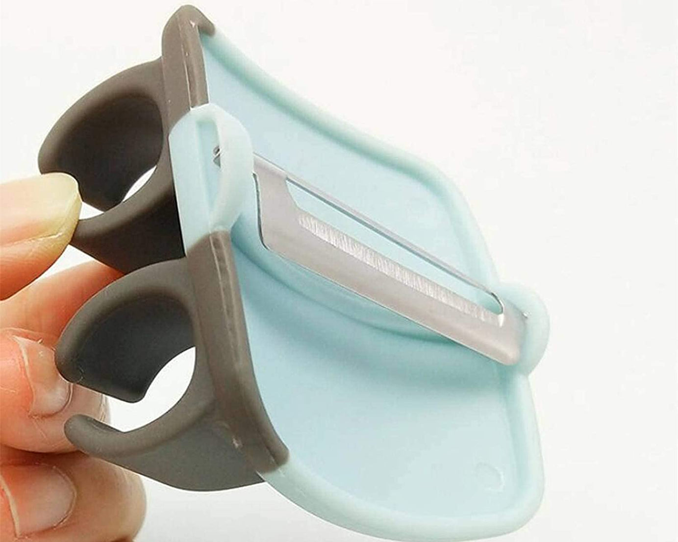 Hand palm vegetable peeler with rubber grip.