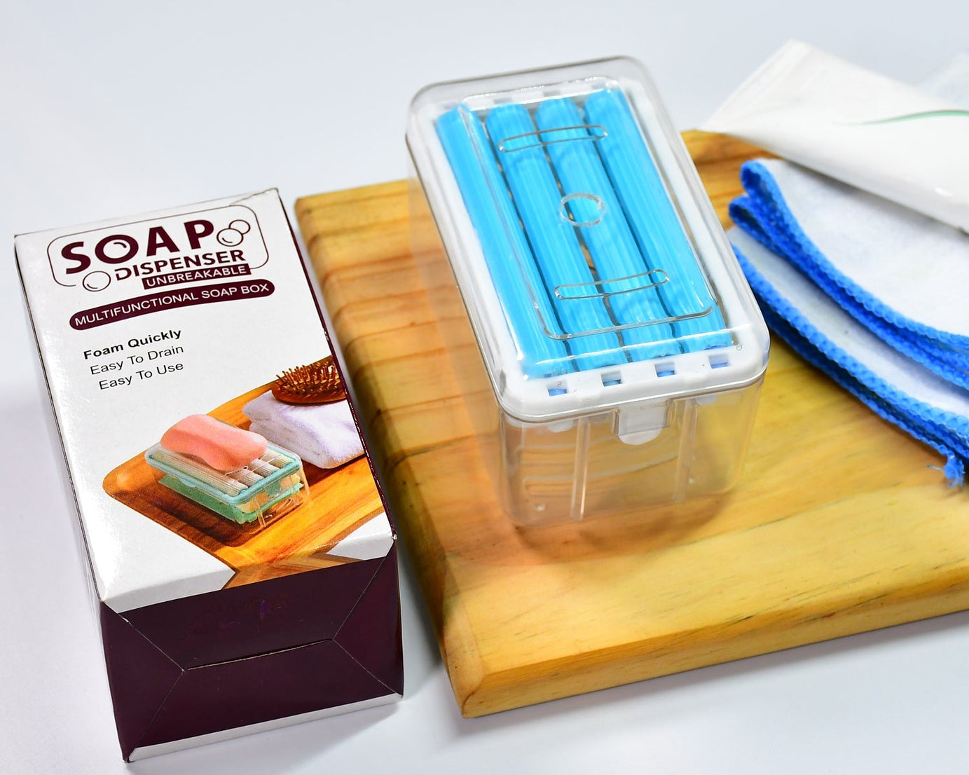 Portable soap dish with roller and drainage for effective soap management