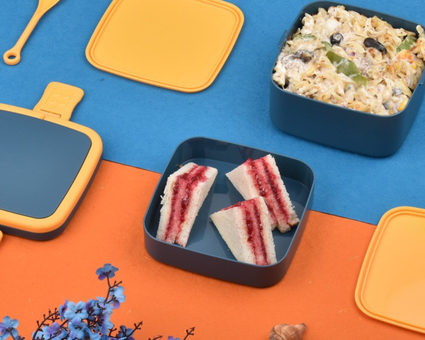 Blue lunch box with handle and spoon for meals