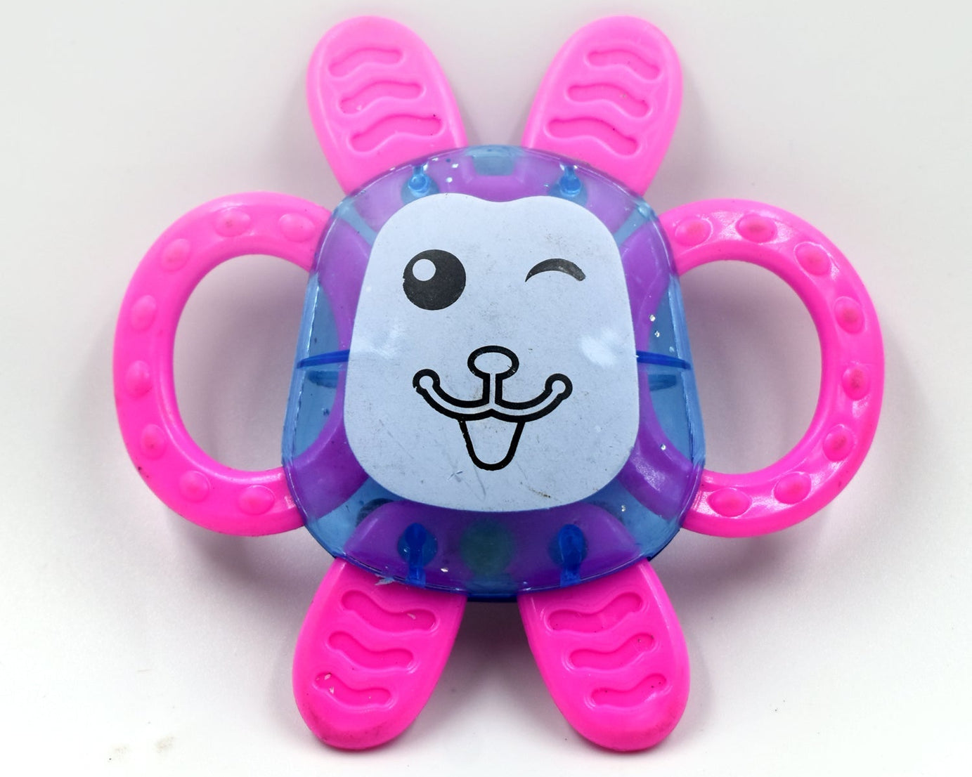 a set of three baby rattles featuring various colors and patterns.