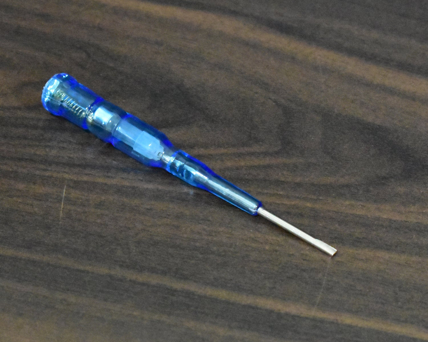 Metal screwdriver with built-in tester for electrical applications.