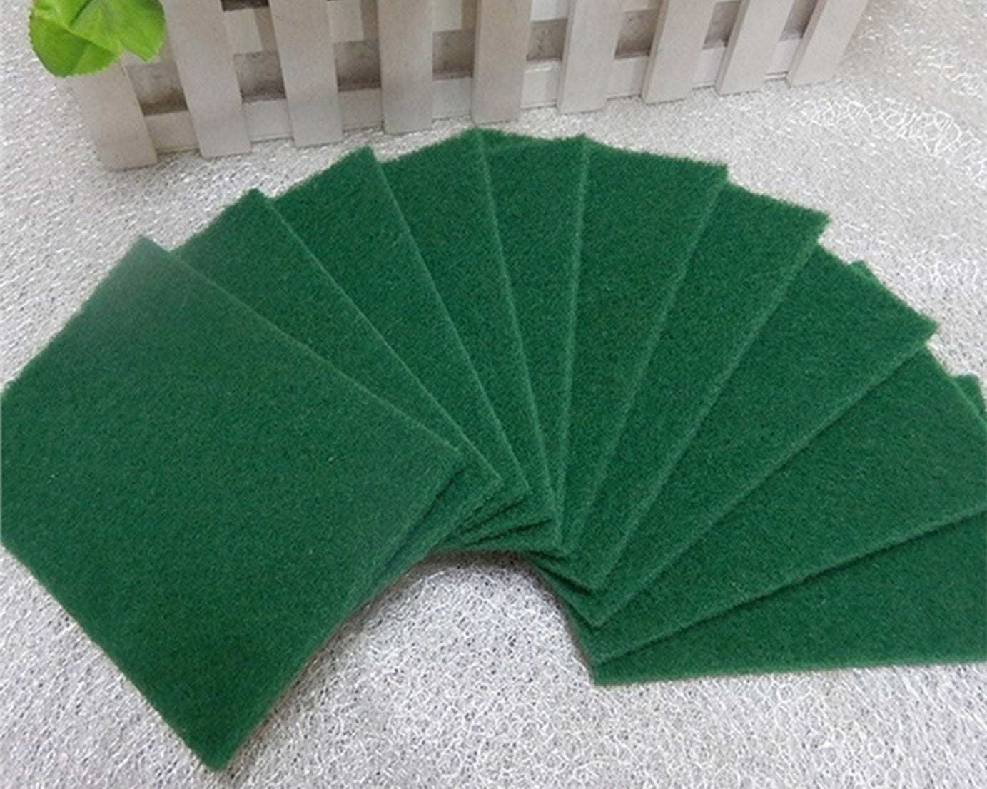 Set of 10 aqua green cleaning pads for scrubbing tasks.