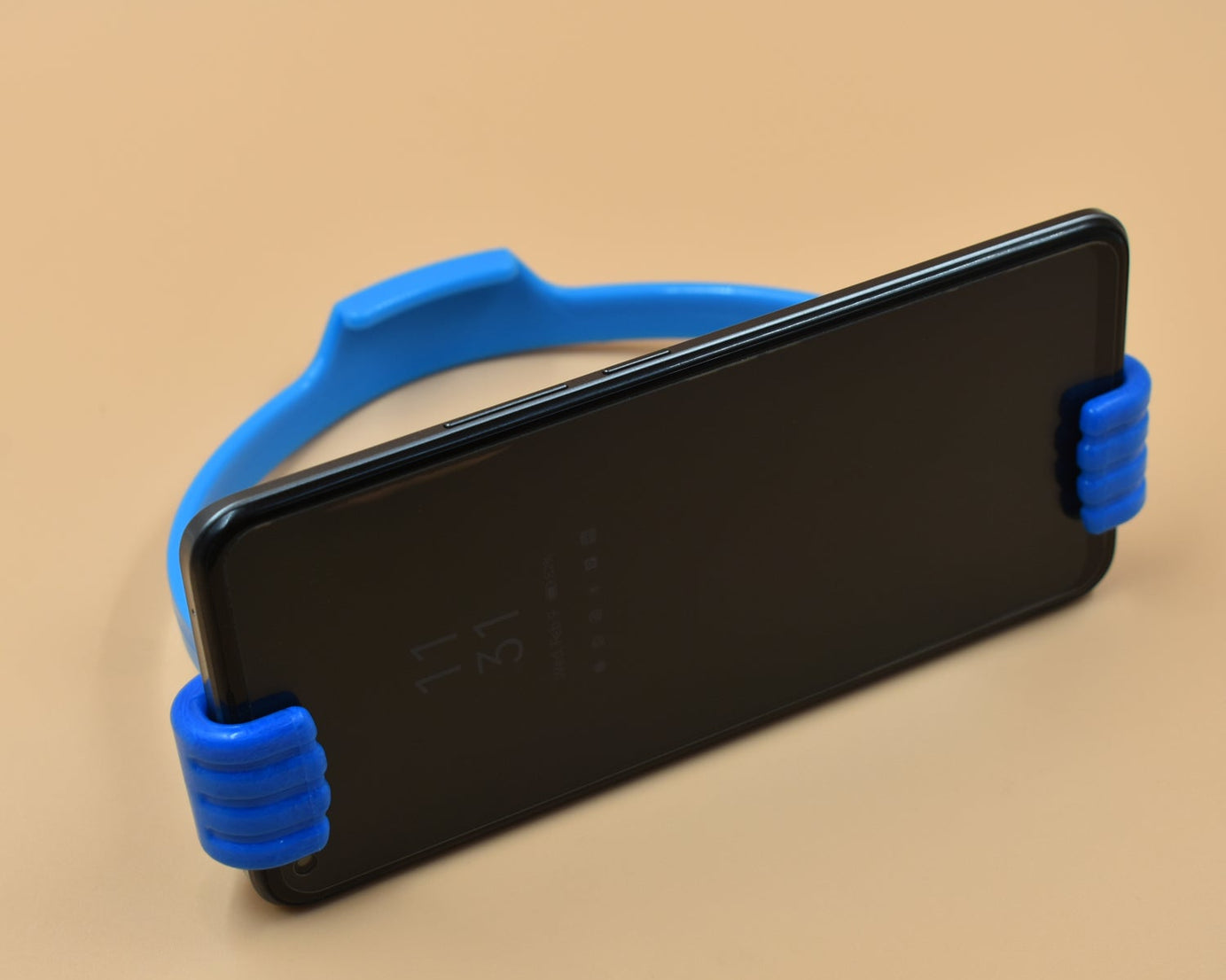 Mobile phone holder with hand shape, useful in home and office spaces.