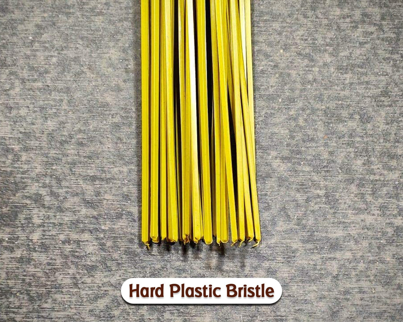 Hard bristle broom with plastic handle, close-up of bristles