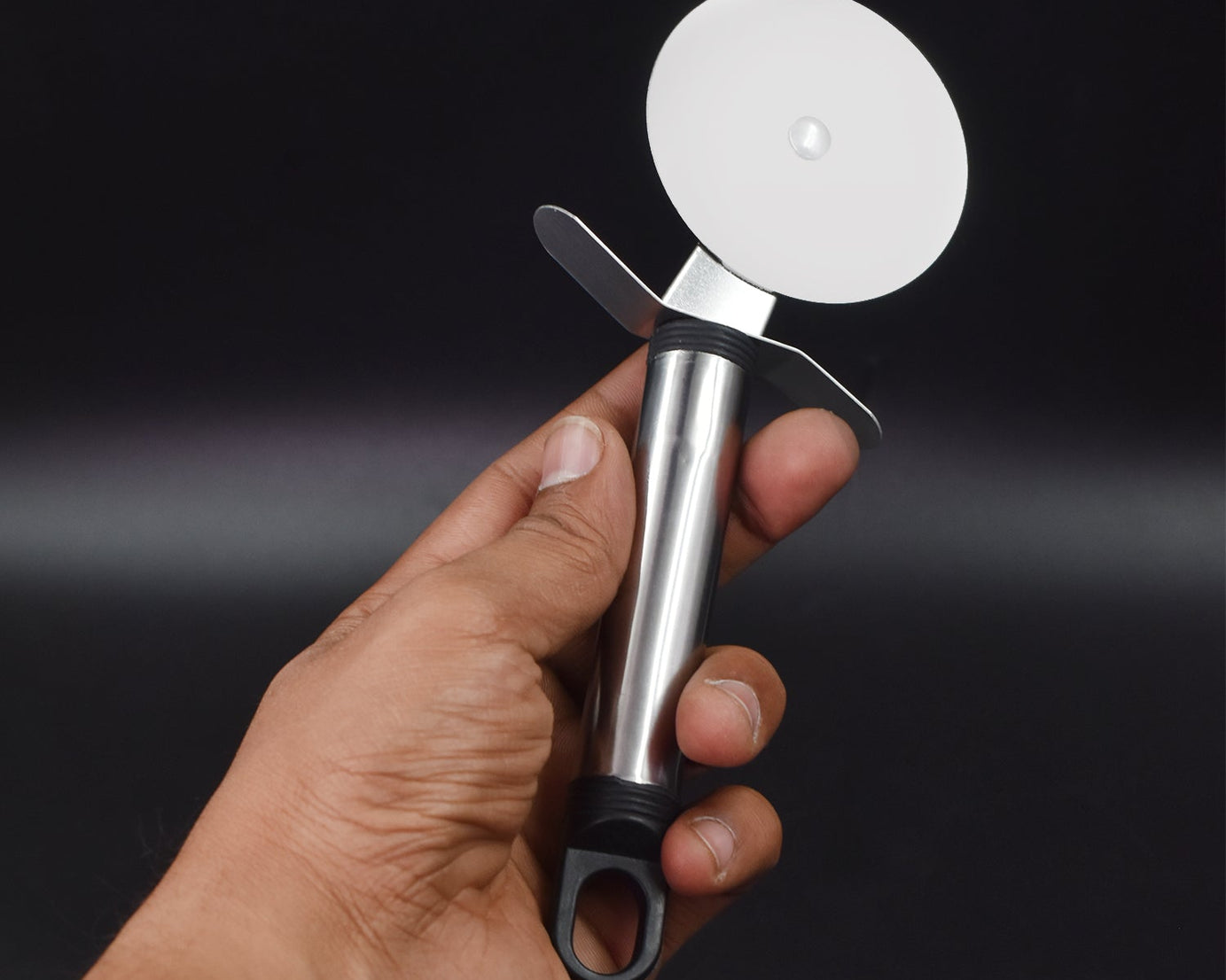 Pizza cutter with sharp wheel for precise slicing.