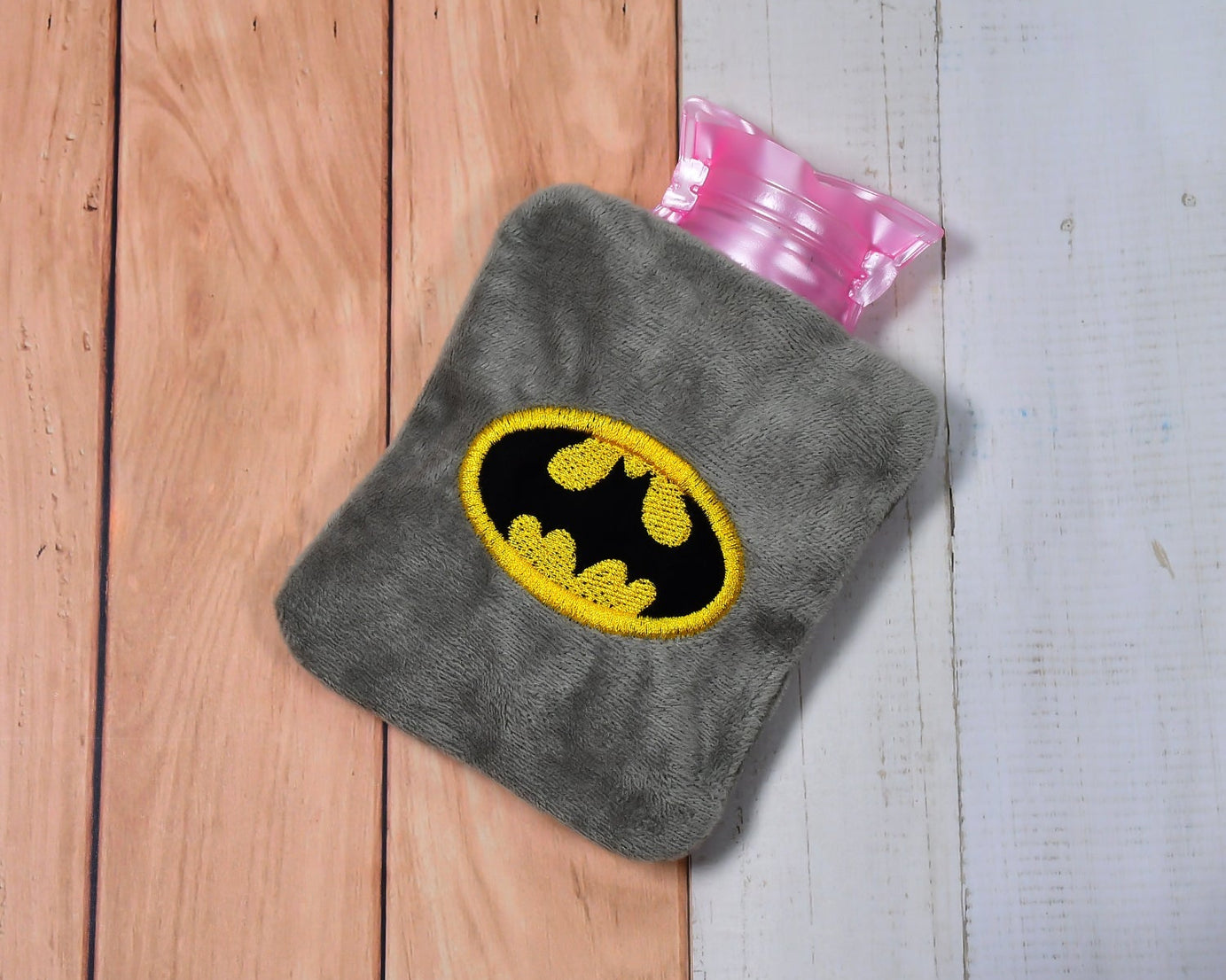 Hot water bag with Batman cover for cramps and pain relief