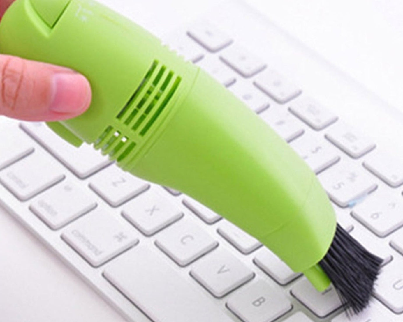 Compact and portable mini vacuum cleaner for targeted cleaning of electronic devices.