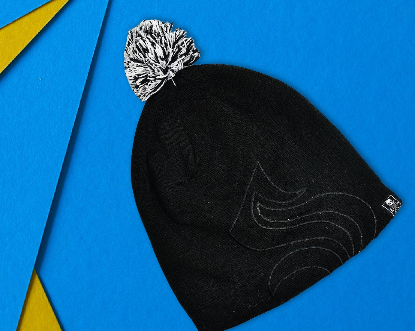 Black inside fur beanie cap with a skull design.