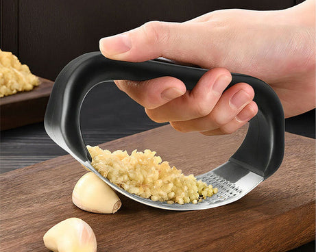 Sturdy garlic presser in multicolour for kitchen use.