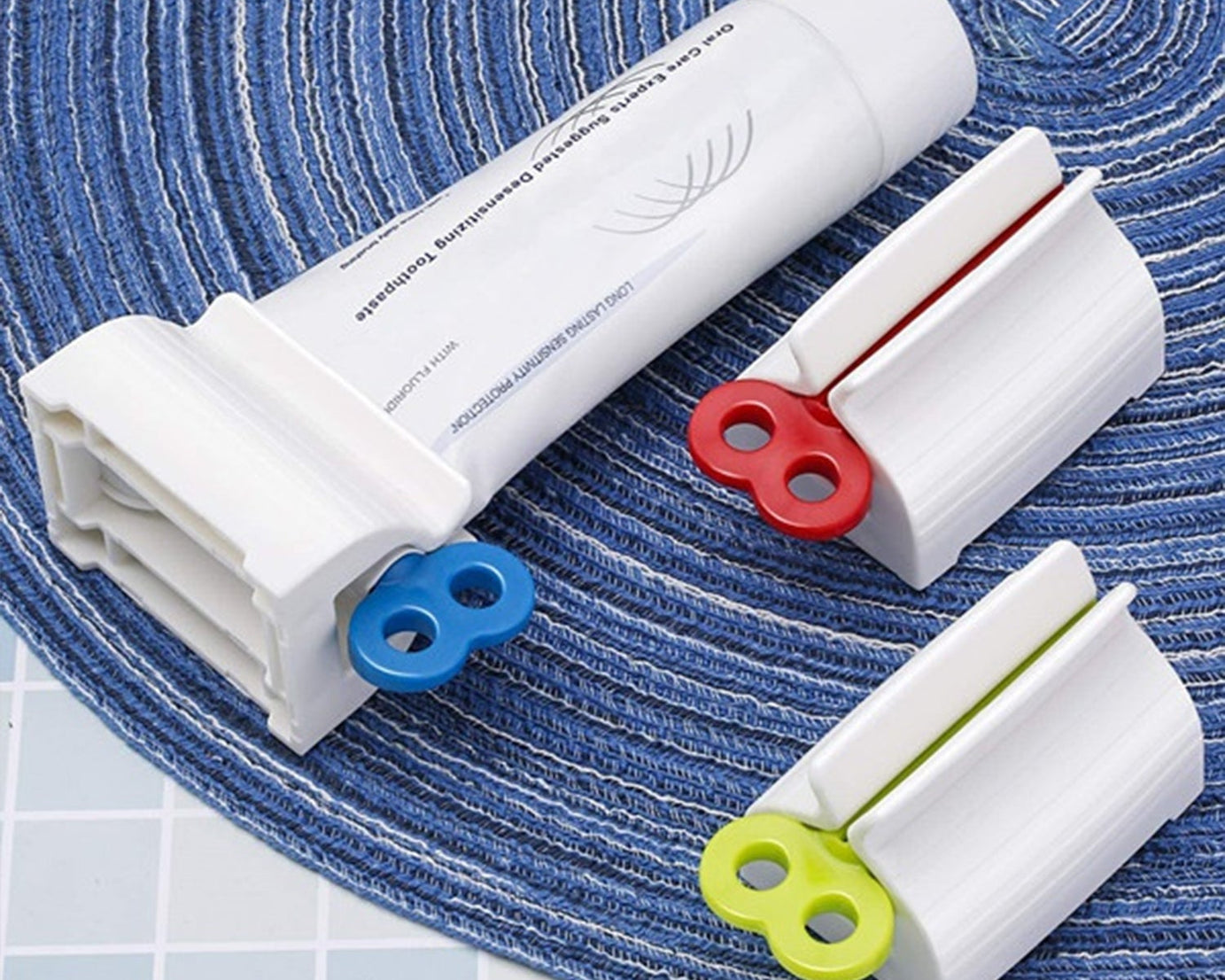 Stand for toothpaste tubes with built-in squeezer