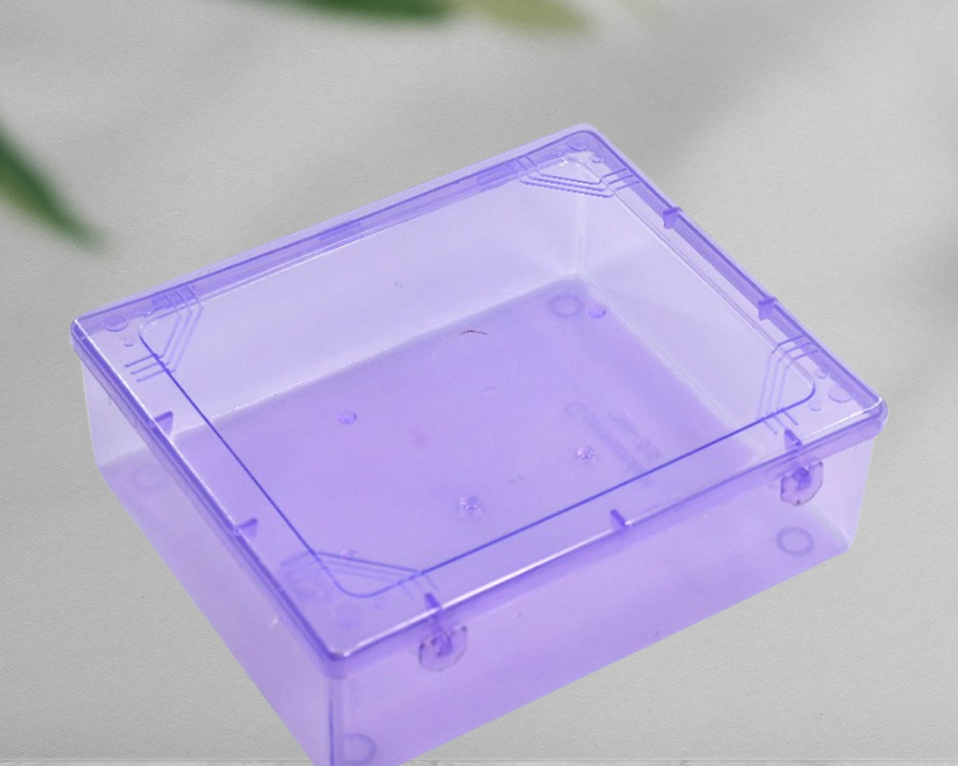 Transparent plastic storage container with lid, ideal for storing household items and organizing spaces.