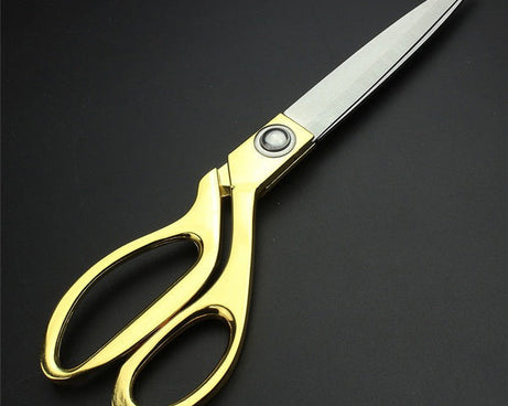 Gold-plated professional scissors for cutting cloth.