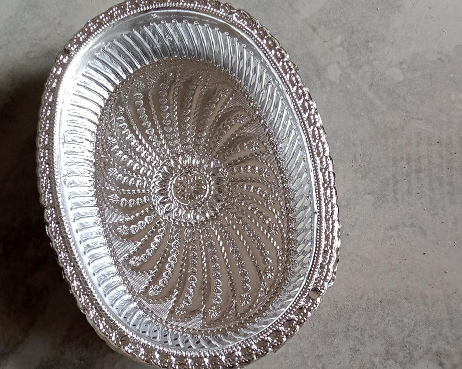 Multipurpose oval silver tray with a royal pattern for various uses.