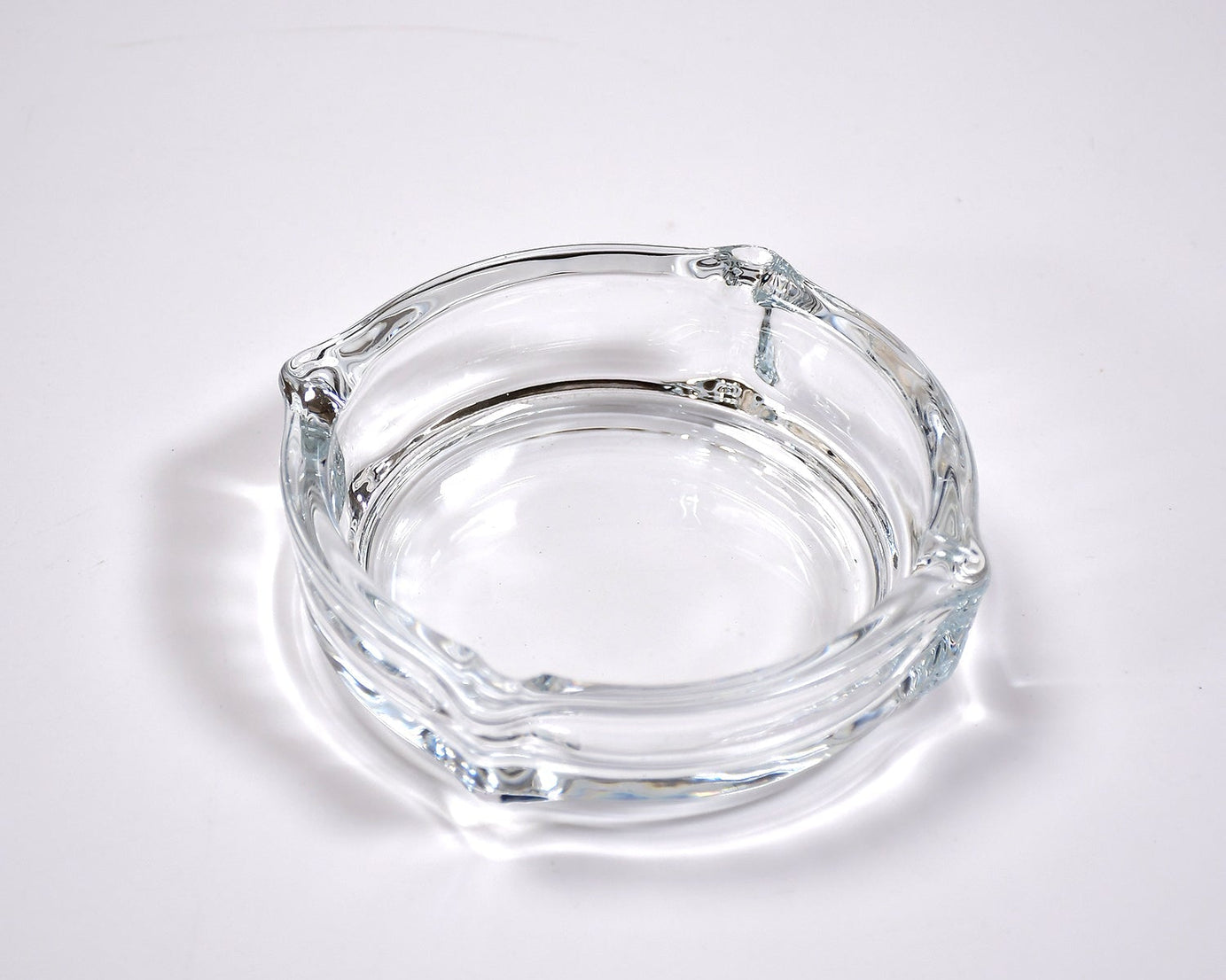Glass ashtray with round design.