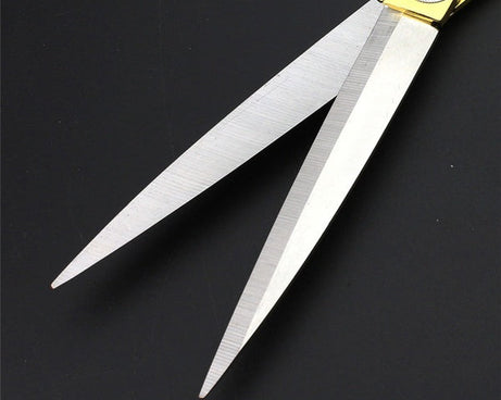 Professional gold-plated scissors for precise fabric cutting.
