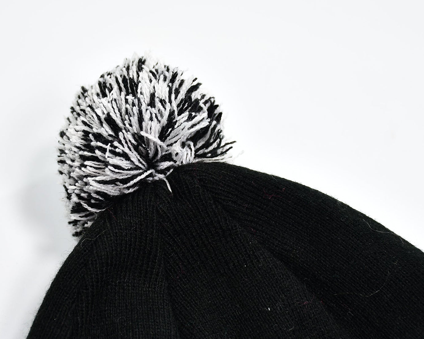 Woolen knitted beanie cap with skull pattern.