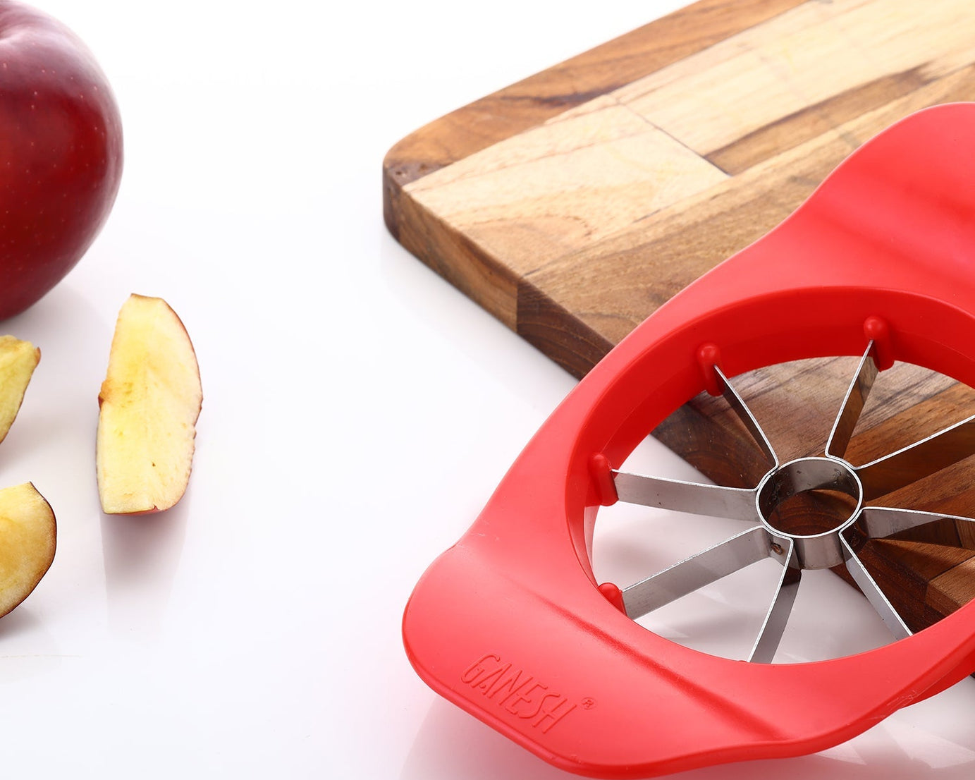 Ganesh apple cutter, plastic and stainless steel, available in various colors.