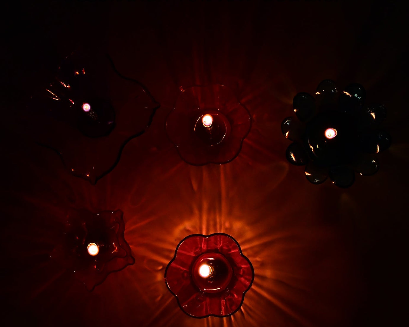 Collection of 12 diya cups with a magical reflection design