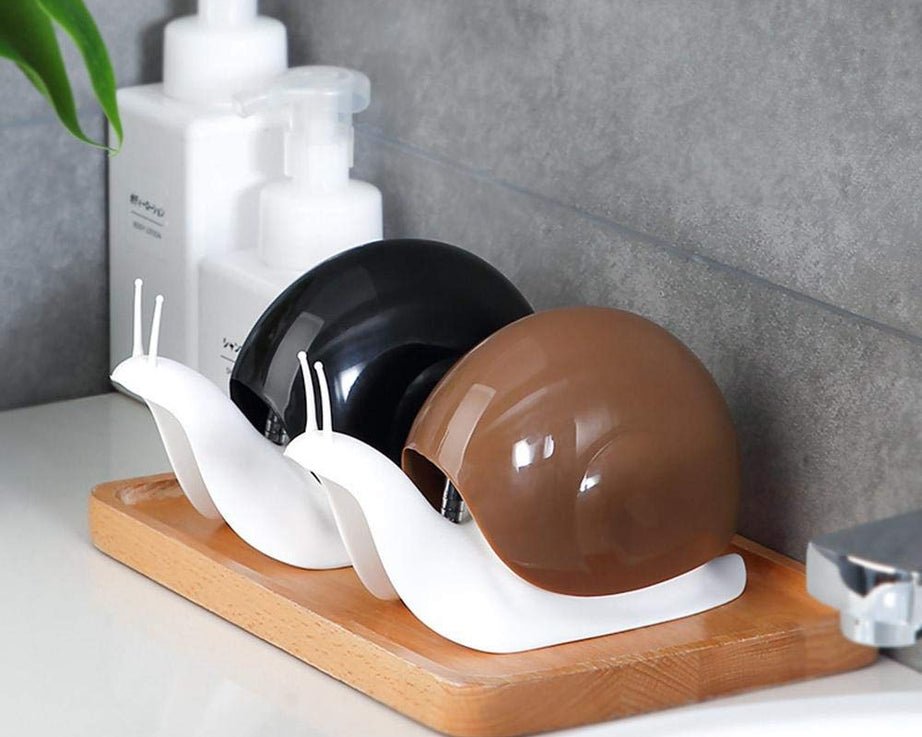 Unique snail-shaped soap dispenser for convenient liquid soap access.