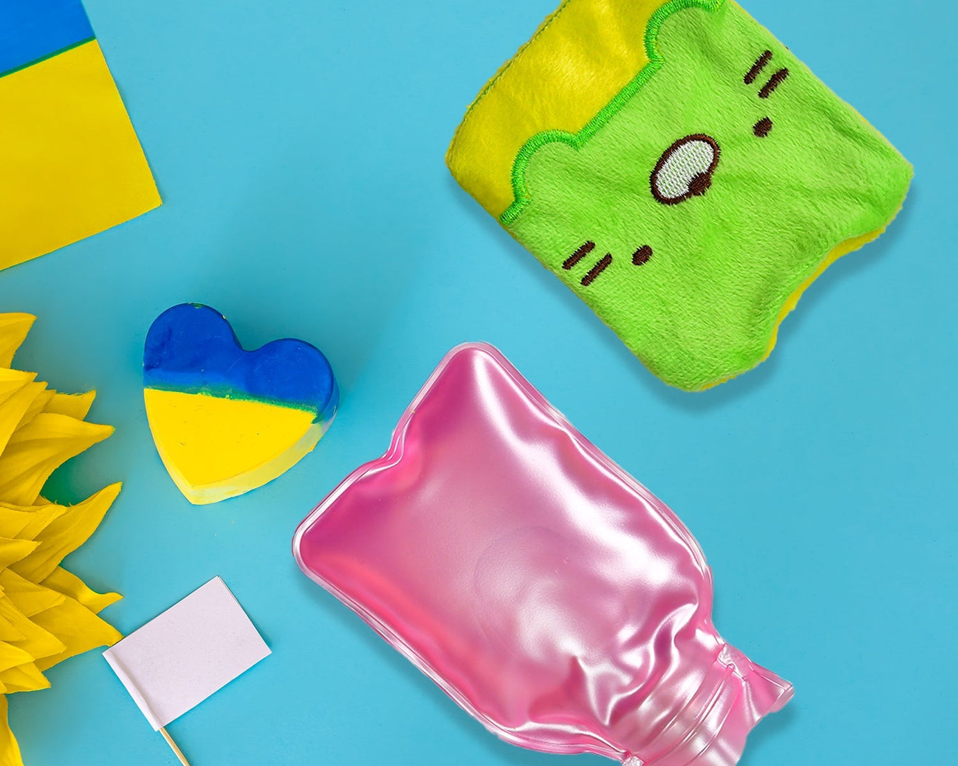 Green Kitty hot water bag with cover for pain relief and warming
