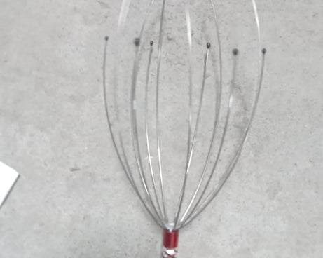 Handheld scalp massager for effective stress relief and relaxation.