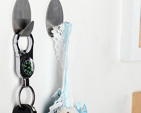 Pack of 3 heavy-duty adhesive wall hooks, durable.