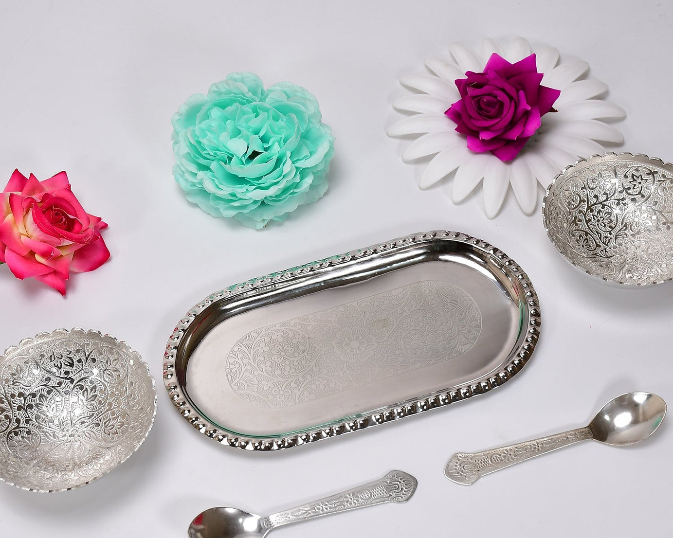Serving set with silver bowls and spoons.