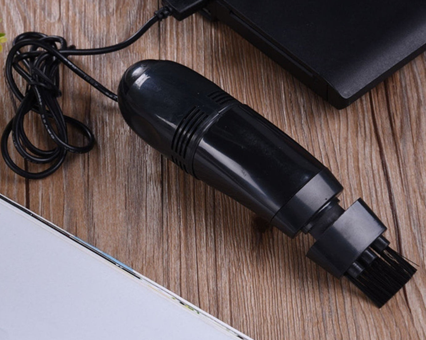 Versatile mini vacuum cleaner for cleaning small debris from electronics and vehicle surfaces.