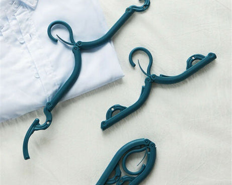 Compact and foldable plastic hanger, multicolor, space-saving design for travel.