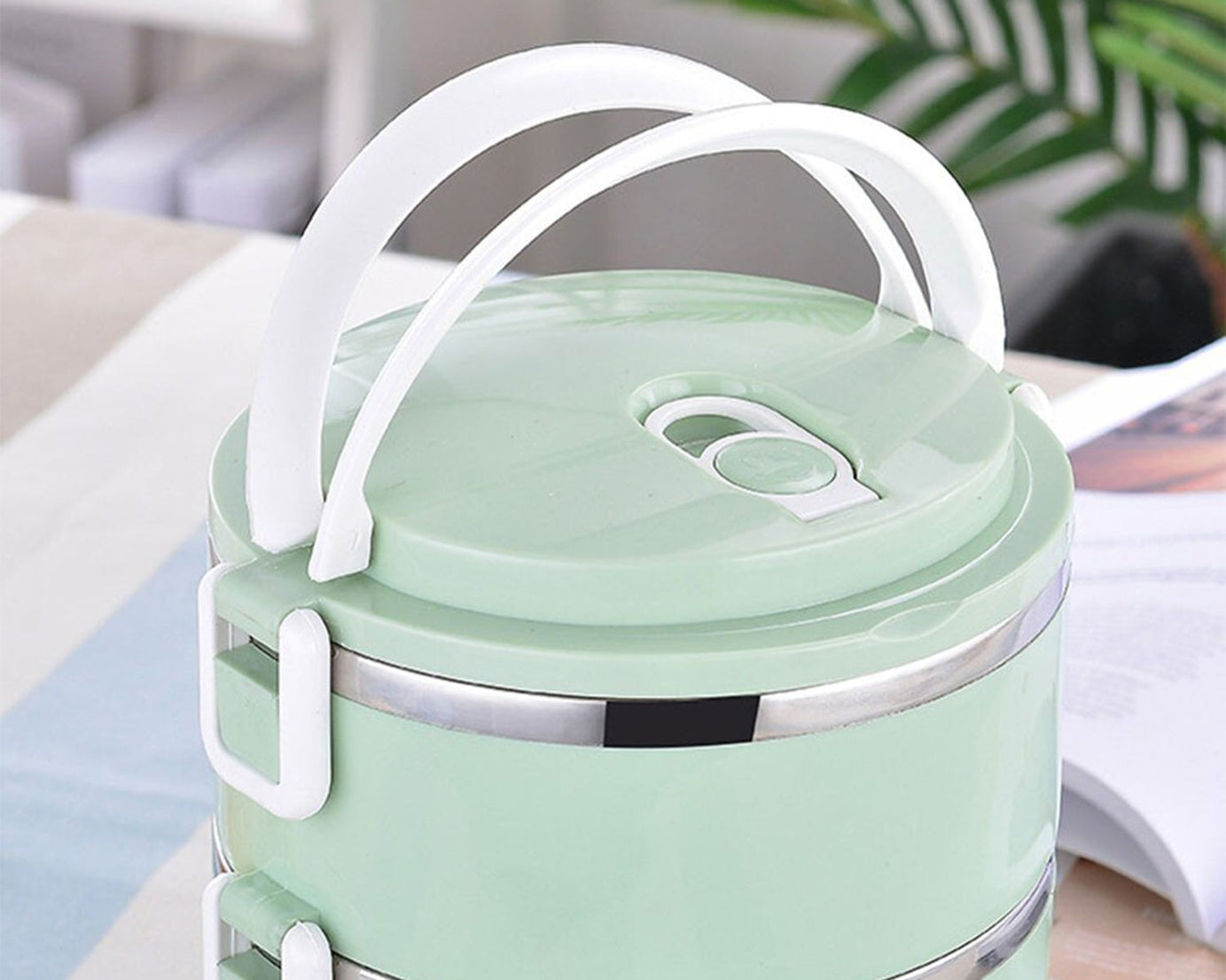 Two layer stainless steel lunch box for keeping food hot.