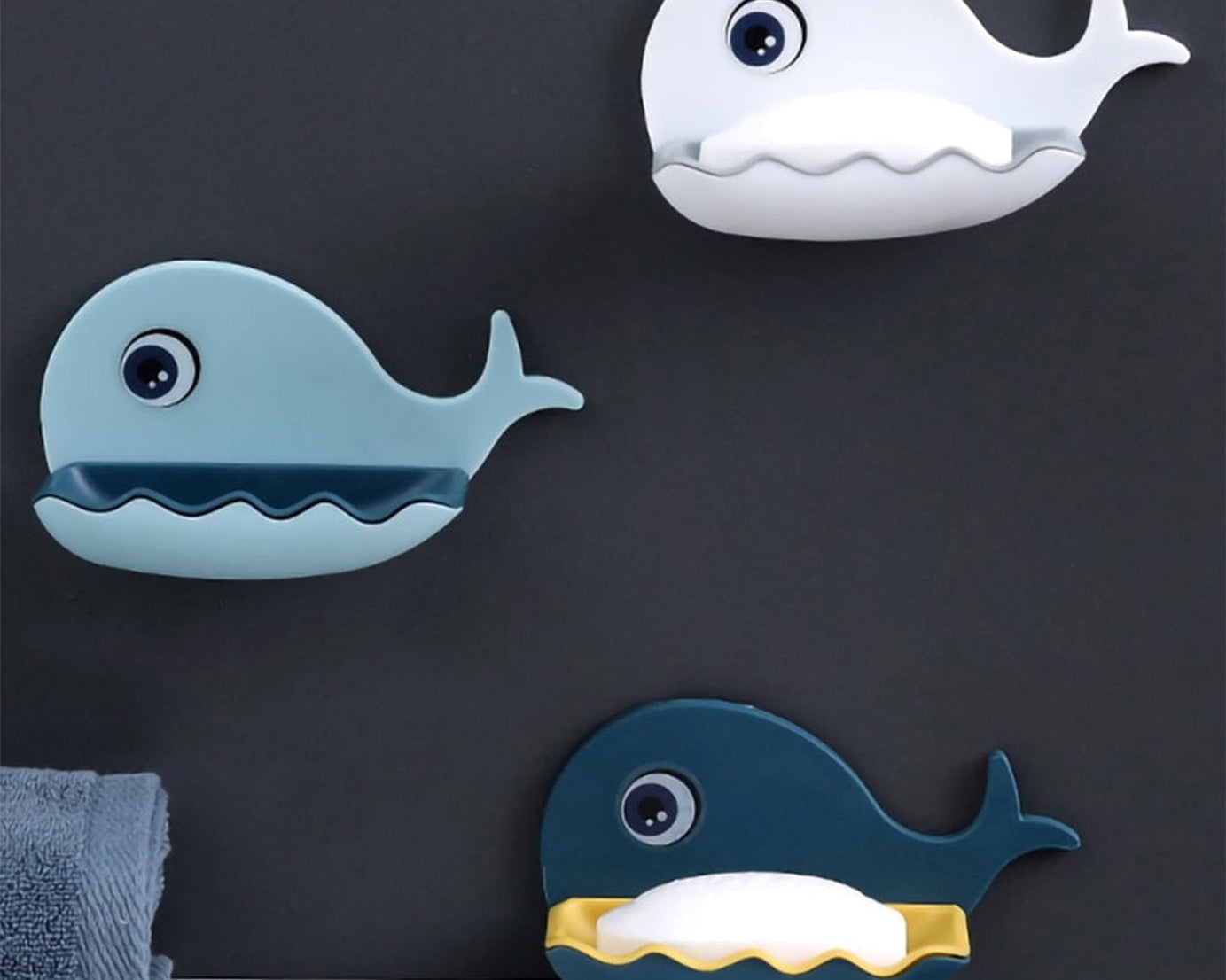 Detailed view of the fish-shaped soap dish holder, highlighting its adhesive feature and drainage design