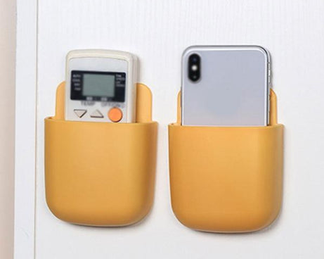 Wall mounted multicolour storage box for remotes.