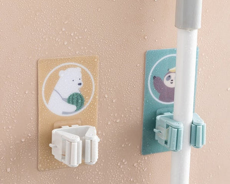 Magic sticker broom and mop holder for home storage solutions.