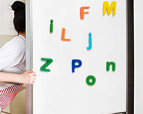 Colorful magnetic letters on a whiteboard