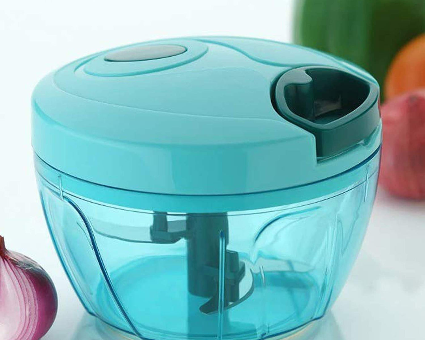 Compact hand-held vegetable chopper with stainless steel blades.