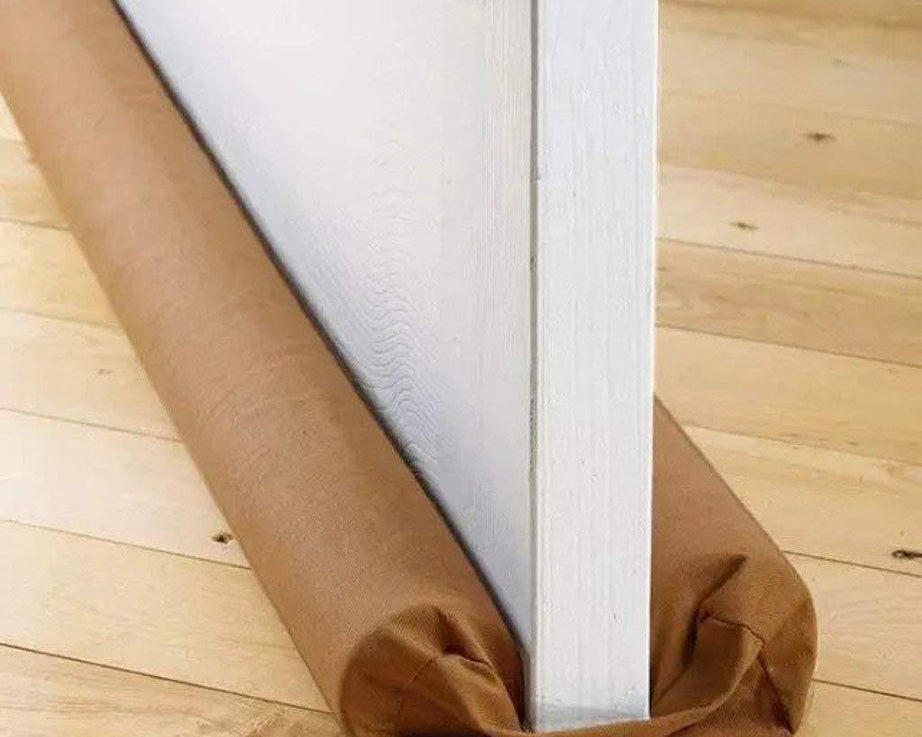 Draft stopper installed at the base of a door