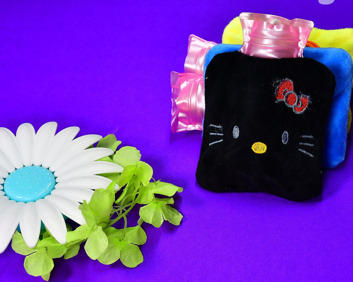 Black hot water bag with Hello Kitty design for menstrual cramps and pain relief