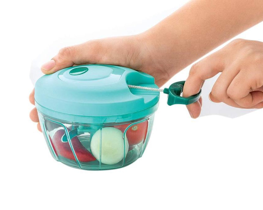 Compact vegetable slicer with stainless steel blades, brown box packaging.